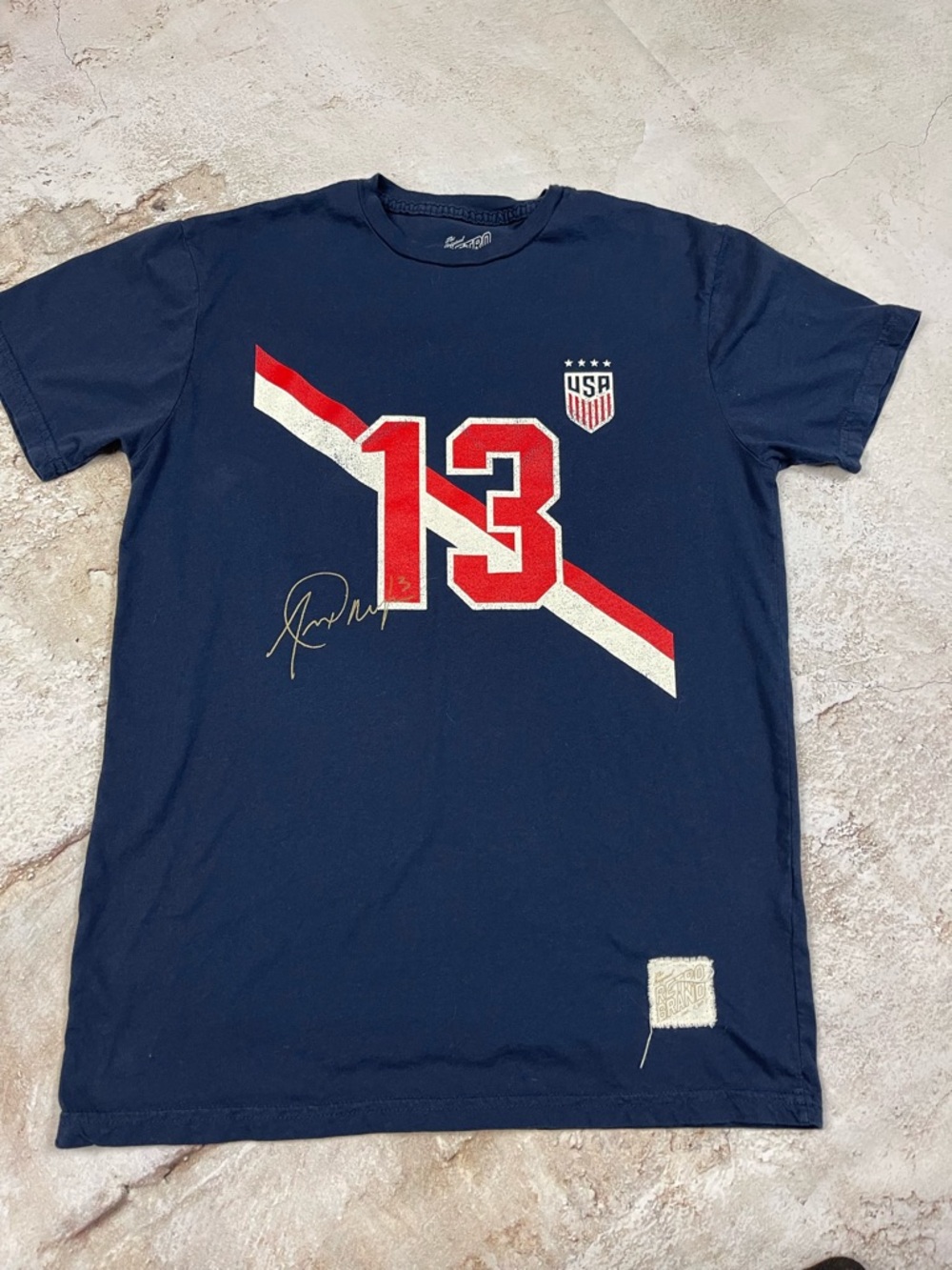 Original Retro Brand Navy Short Sleeve Tee with Red and White Graphics